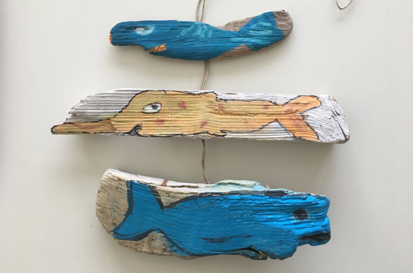 Pieces of wood and stones painted with fish